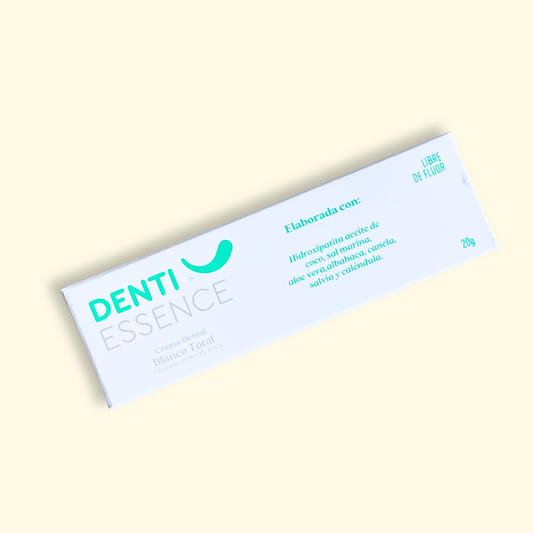 la crema dental sin fluor  de denti essence 20g en su  caja con fondo plano