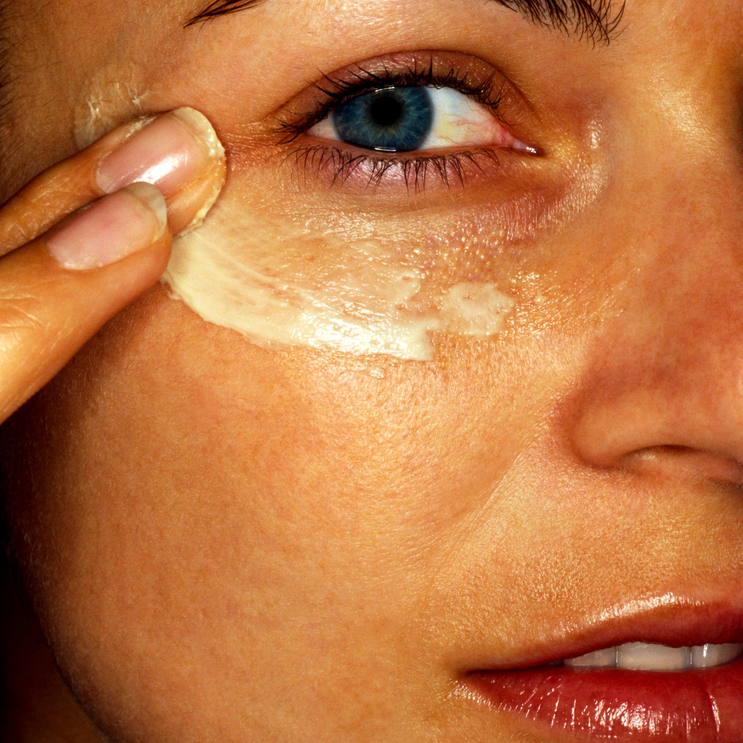 una mujer usando el contorno de ojos termalcare en su cara. 