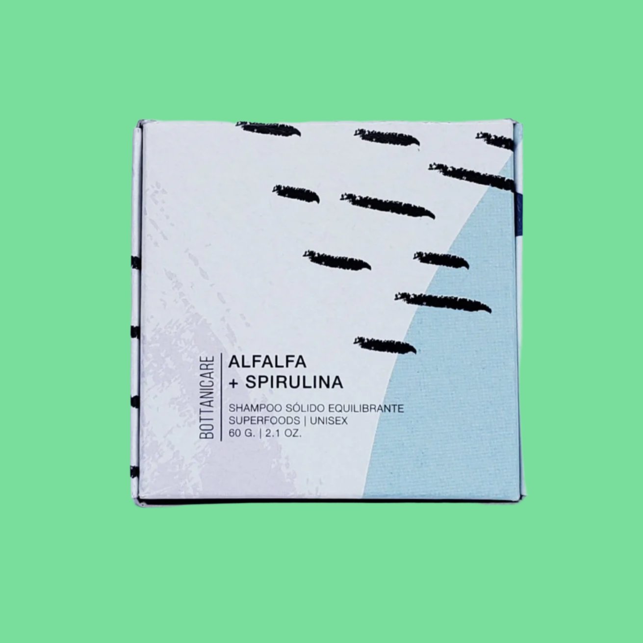 El shampoo solido alfalfa y spirulina 60g de bottanicare con su caja con fondo plano.